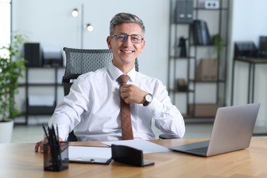 Photo of Portrait of businessman at table in office