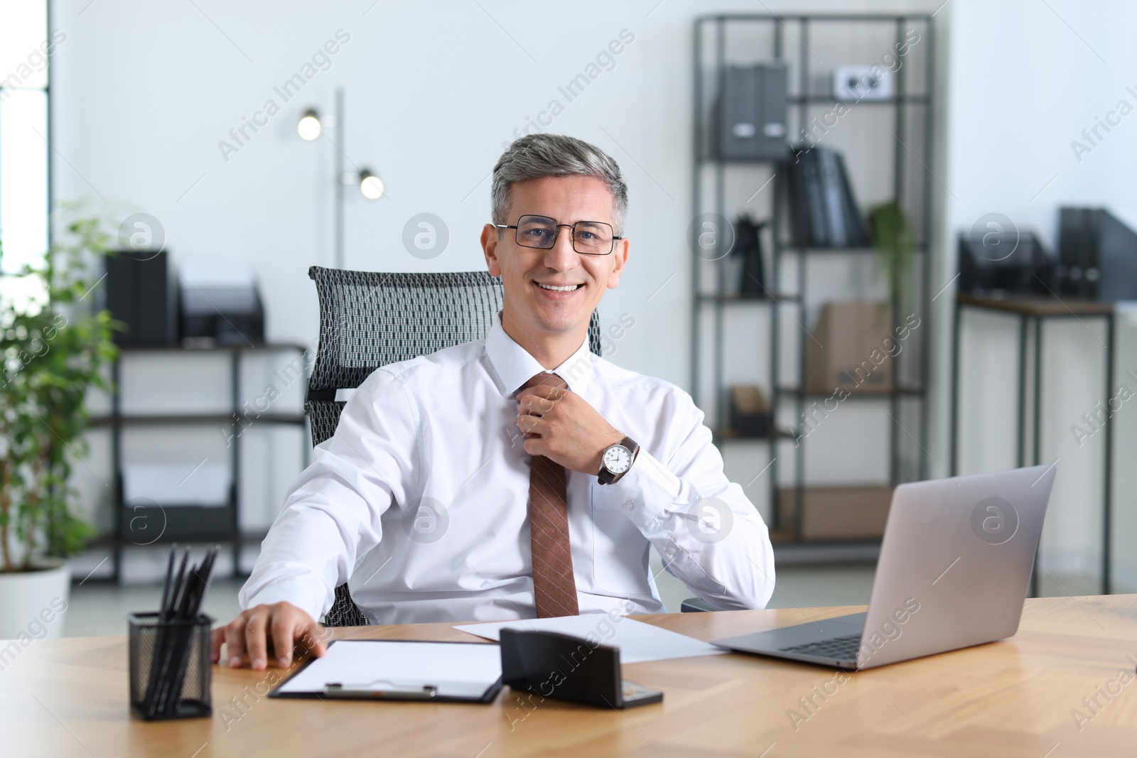 Photo of Portrait of businessman at table in office