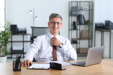 Photo of Portrait of businessman at table in office