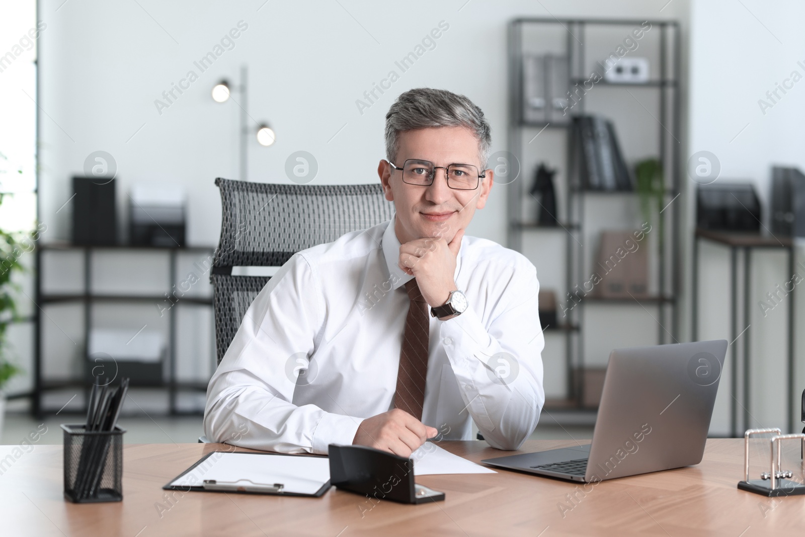 Photo of Portrait of businessman at table in office