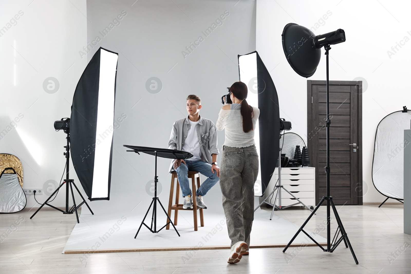 Photo of Photographer working with model in professional photo studio