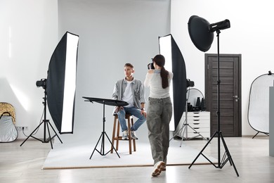 Photo of Photographer working with model in professional photo studio