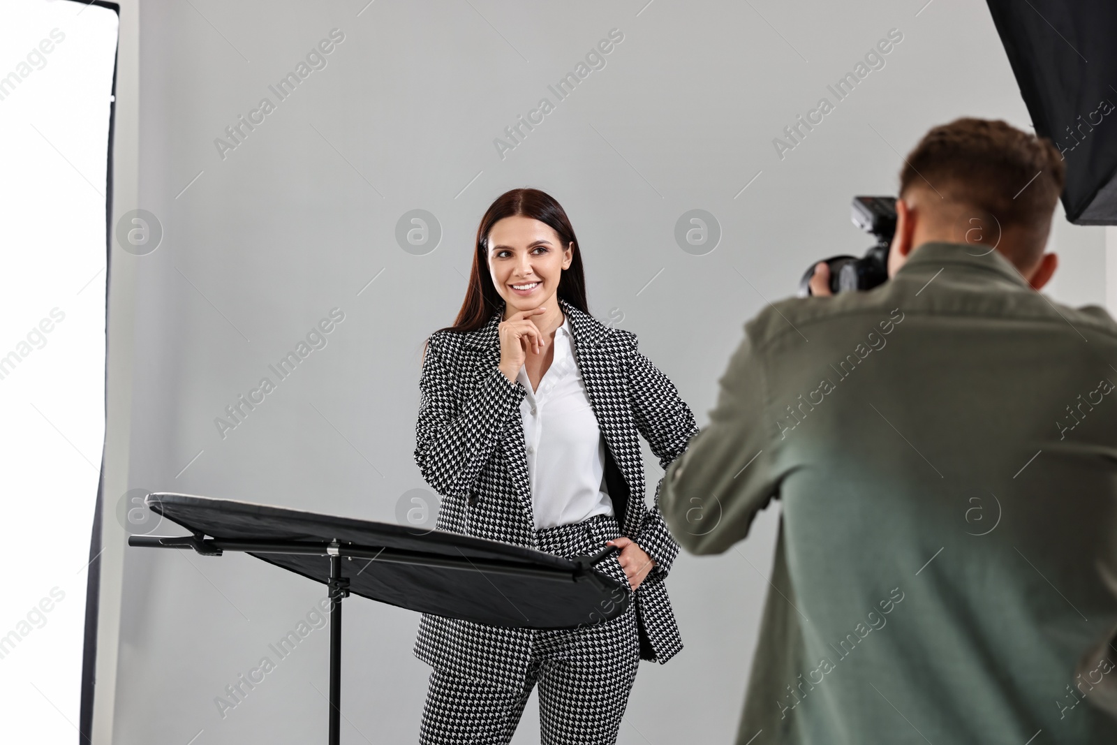 Photo of Photographer working with model in professional photo studio