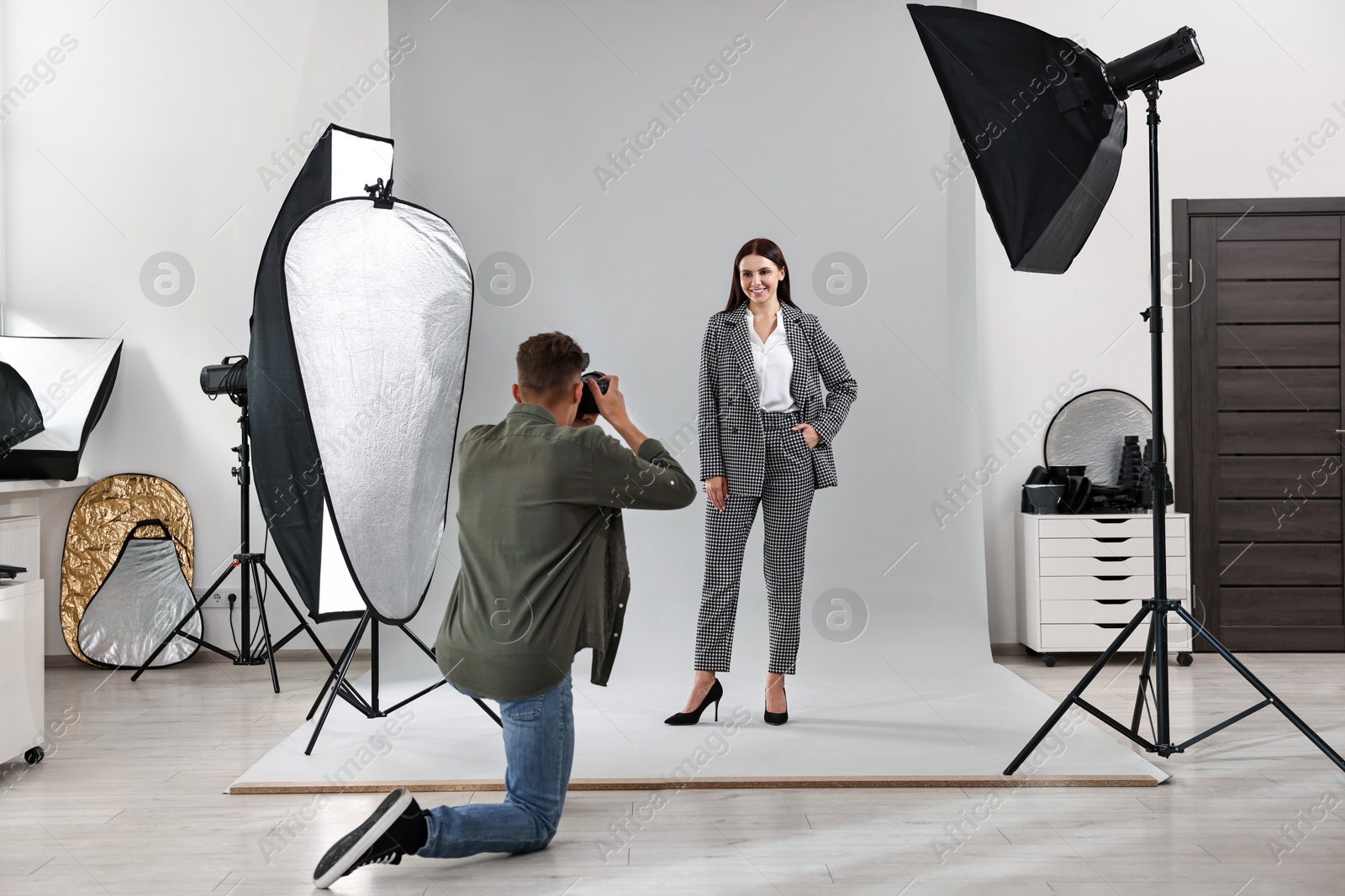 Photo of Photographer working with model in professional photo studio