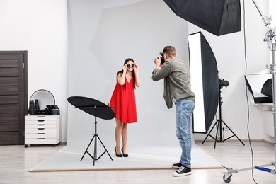 Photo of Photographer working with model in professional photo studio