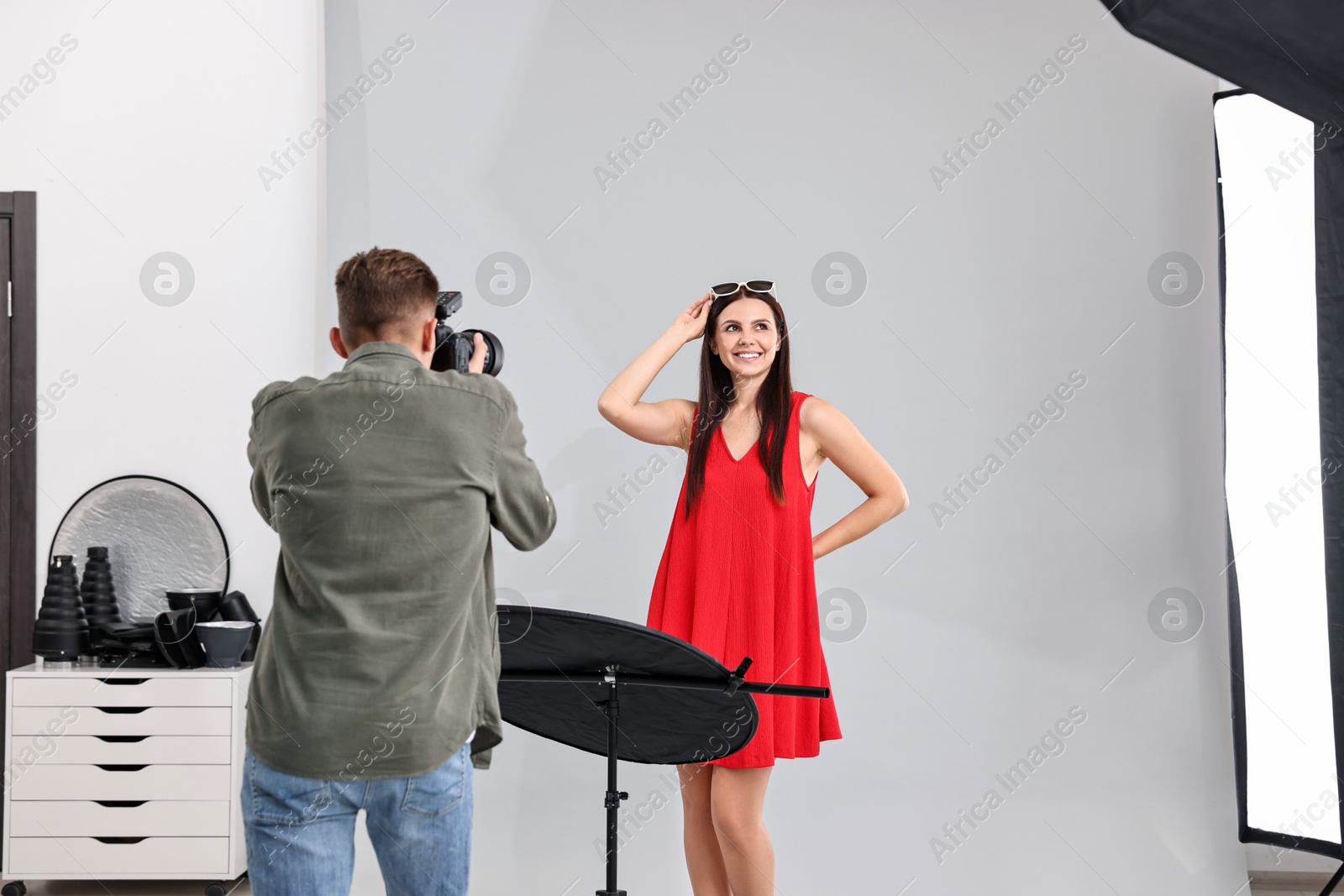 Photo of Photographer working with model in professional photo studio