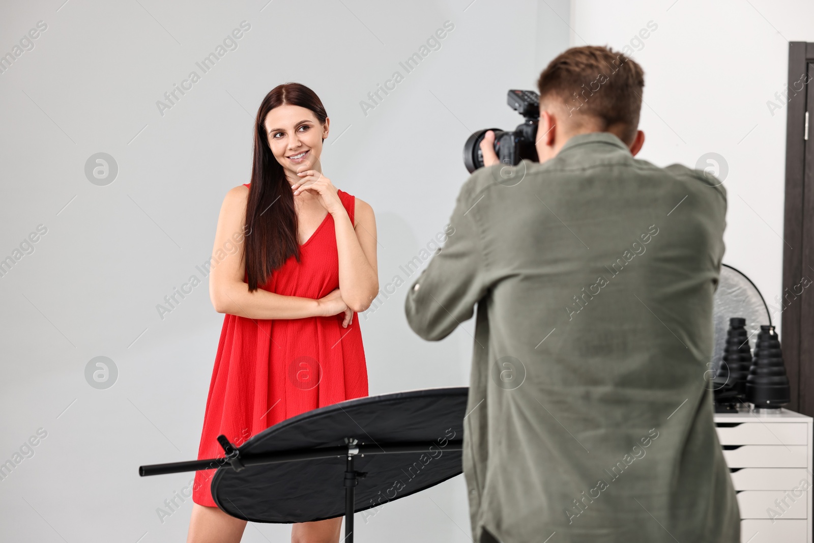 Photo of Photographer working with model in professional photo studio