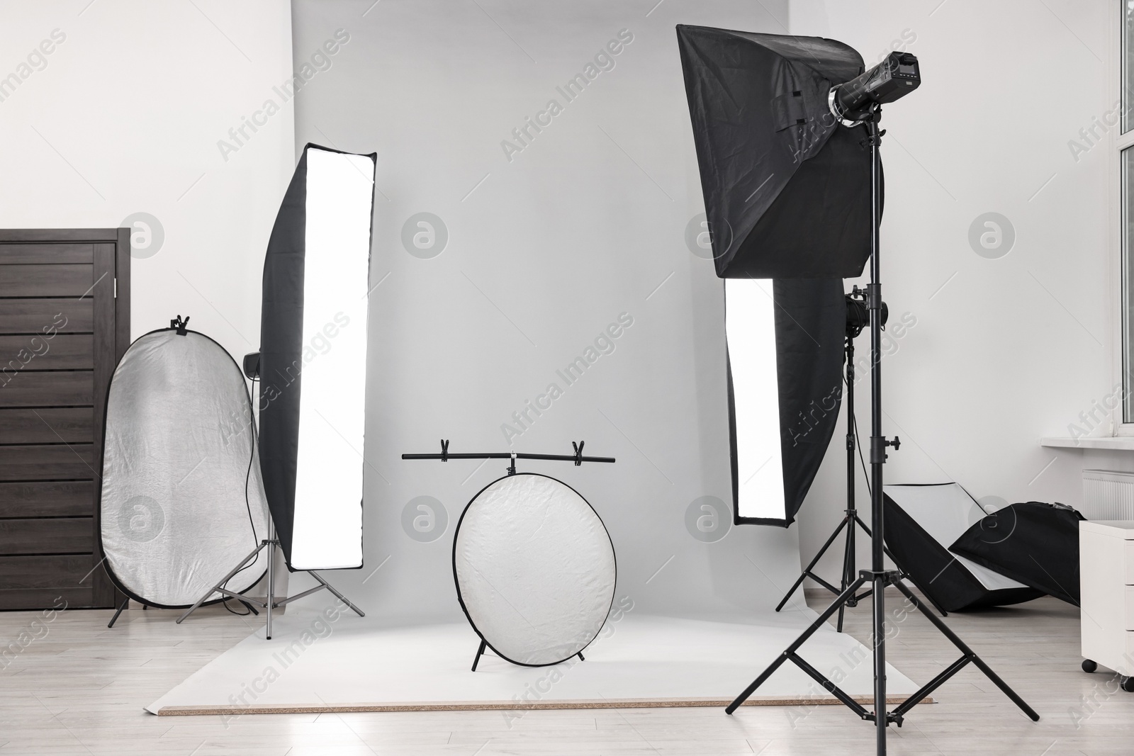 Photo of Professional lighting equipment setup in modern photo studio