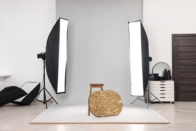 Photo of Professional lighting equipment setup in modern photo studio