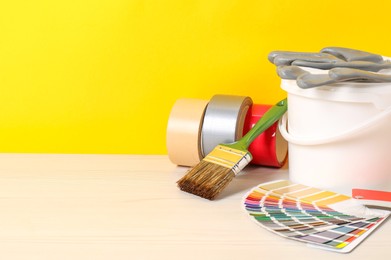 Photo of Different painter's tools on white wooden table, space for text. Decorating and design