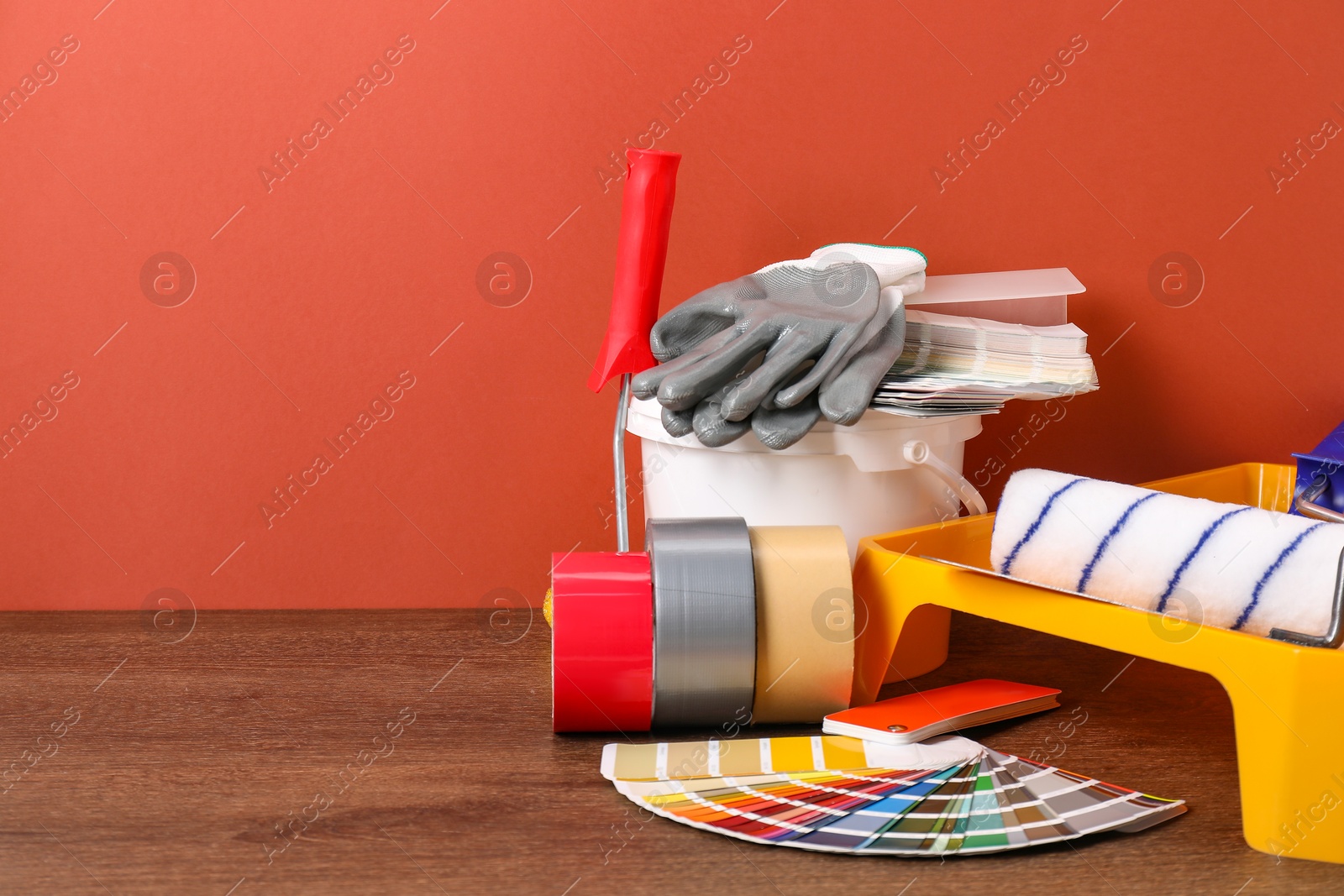 Photo of Different painter's tools on wooden table, space for text. Decorating and design