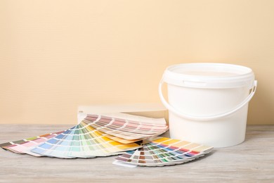 Photo of Different painter's tools on light wooden table. Decorating and design