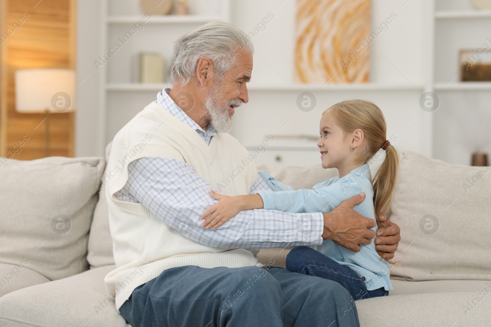 Photo of Grandpa and his granddaughter spending time together at home