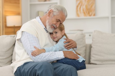 Photo of Grandpa and his granddaughter spending time together at home