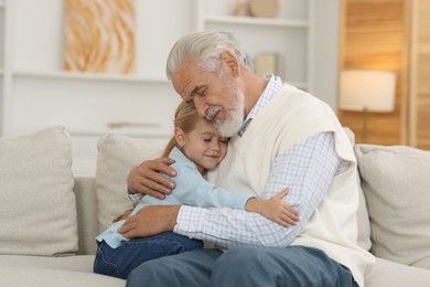 Photo of Grandpa and his granddaughter spending time together at home