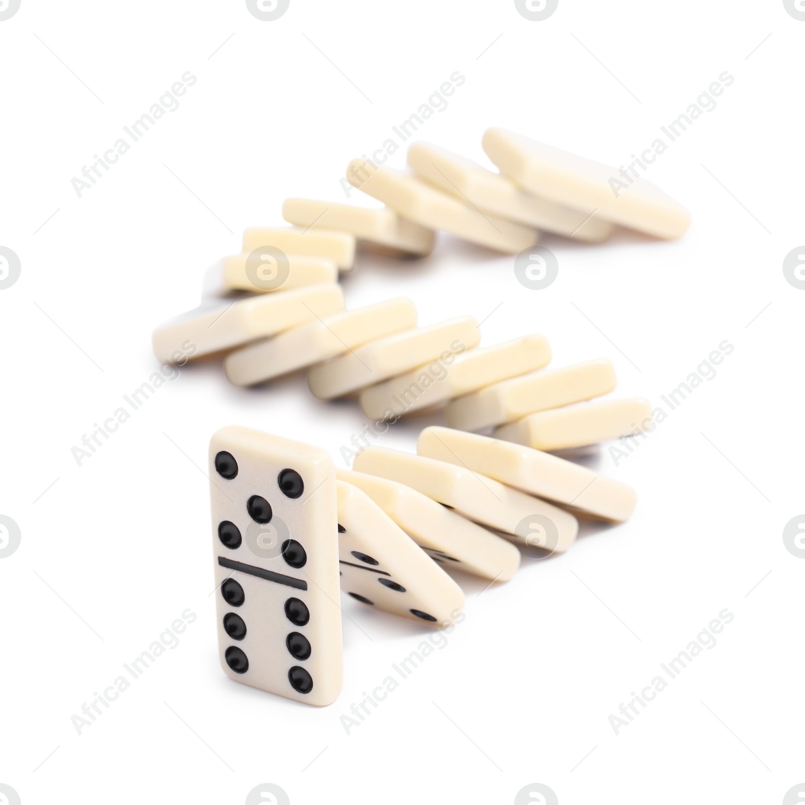 Photo of Domino effect. Tiles falling on white background