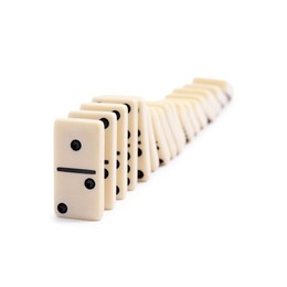 Photo of Domino effect. Tiles falling on white background