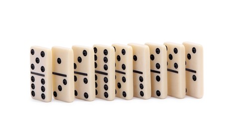 Photo of White domino tiles with black pips isolated on white