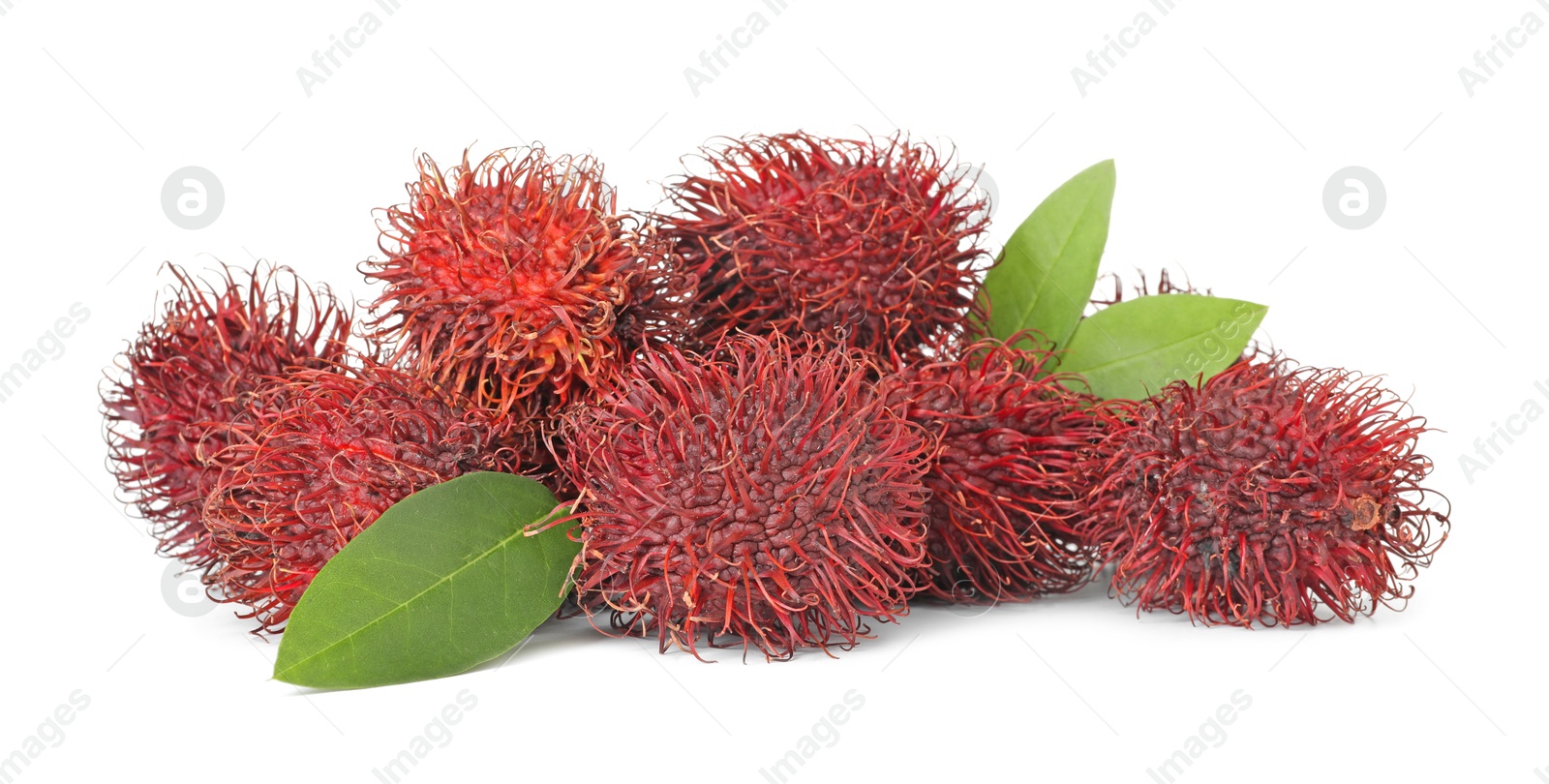 Photo of Delicious ripe rambutans and green leaves isolated on white. Exotic fruit