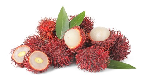 Photo of Delicious ripe rambutans and green leaves isolated on white. Exotic fruit