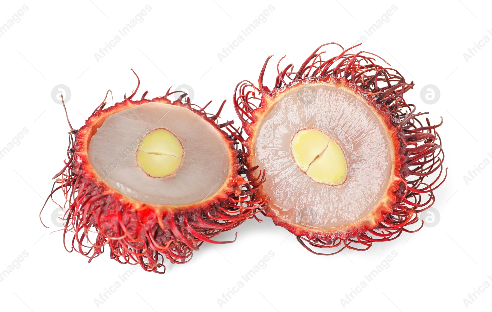 Photo of Halves of ripe rambutan isolated on white. Exotic fruit