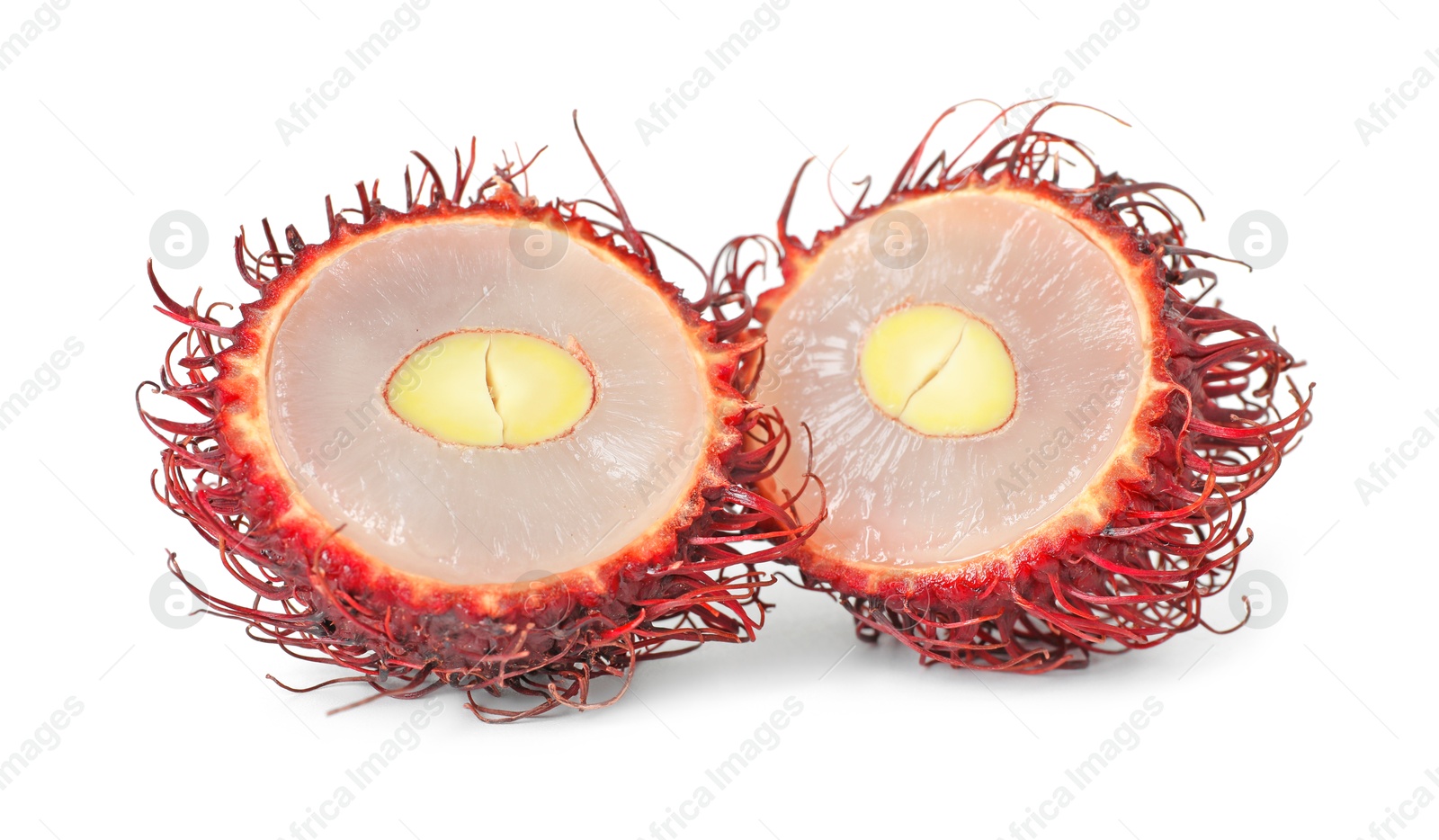 Photo of Halves of ripe rambutan isolated on white. Exotic fruit