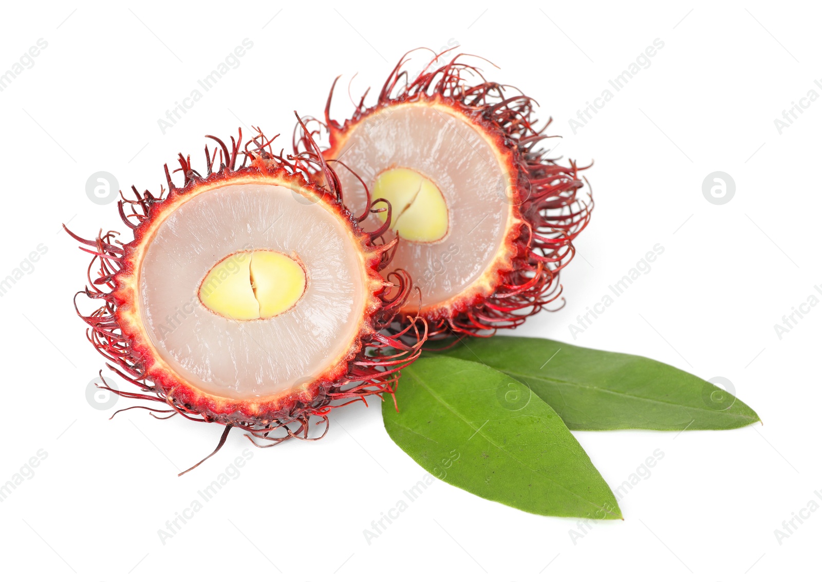 Photo of Halves of ripe rambutan and green leaves isolated on white. Exotic fruit