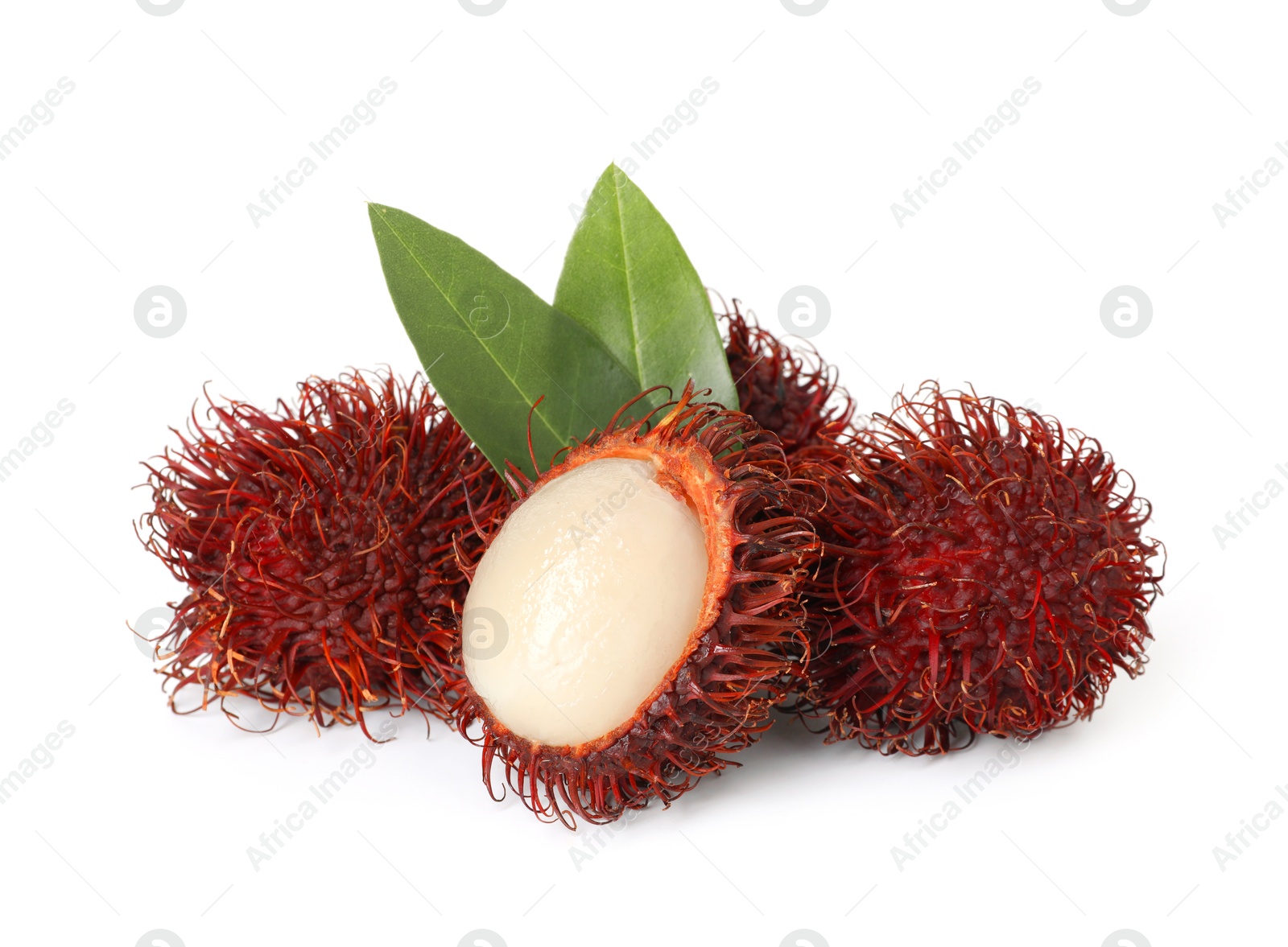 Photo of Delicious ripe rambutans and green leaves isolated on white. Exotic fruit