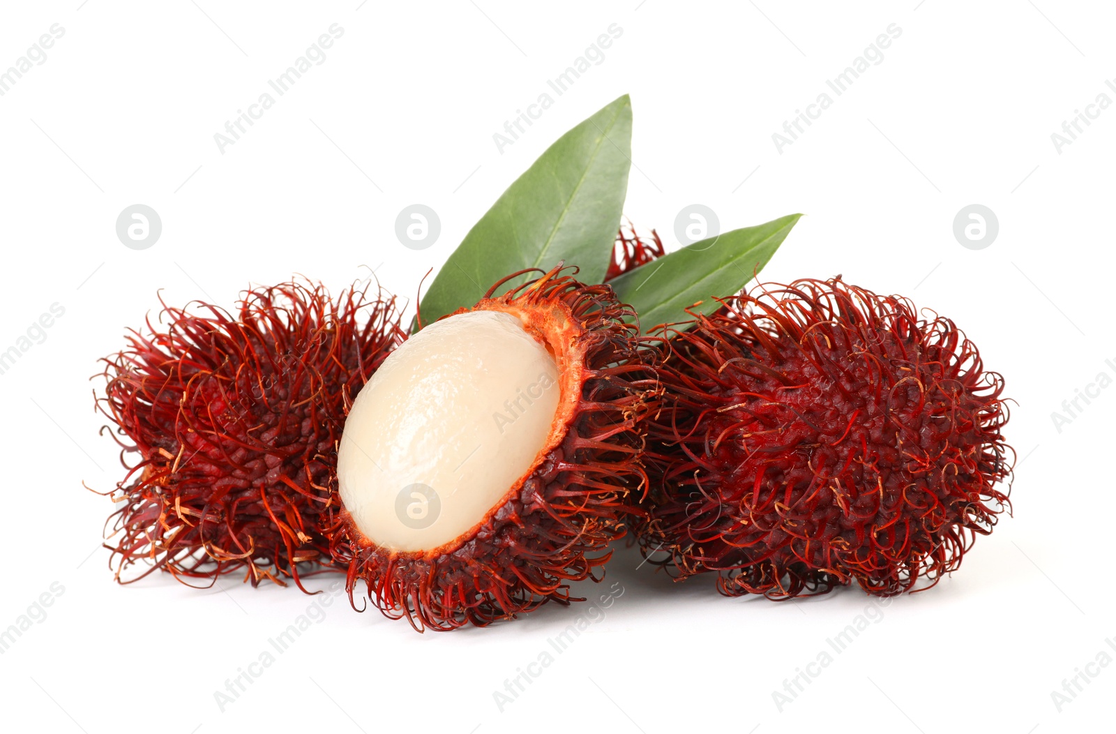 Photo of Delicious ripe rambutans and green leaves isolated on white. Exotic fruit