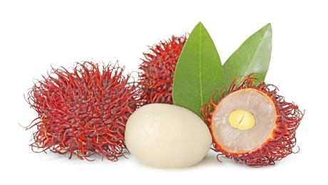 Delicious ripe rambutans and green leaves isolated on white. Exotic fruit