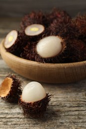 Delicious ripe rambutans on wooden table, closeup