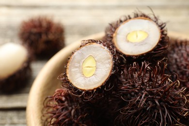 Photo of Delicious ripe rambutans on table, closeup. Exotic fruit