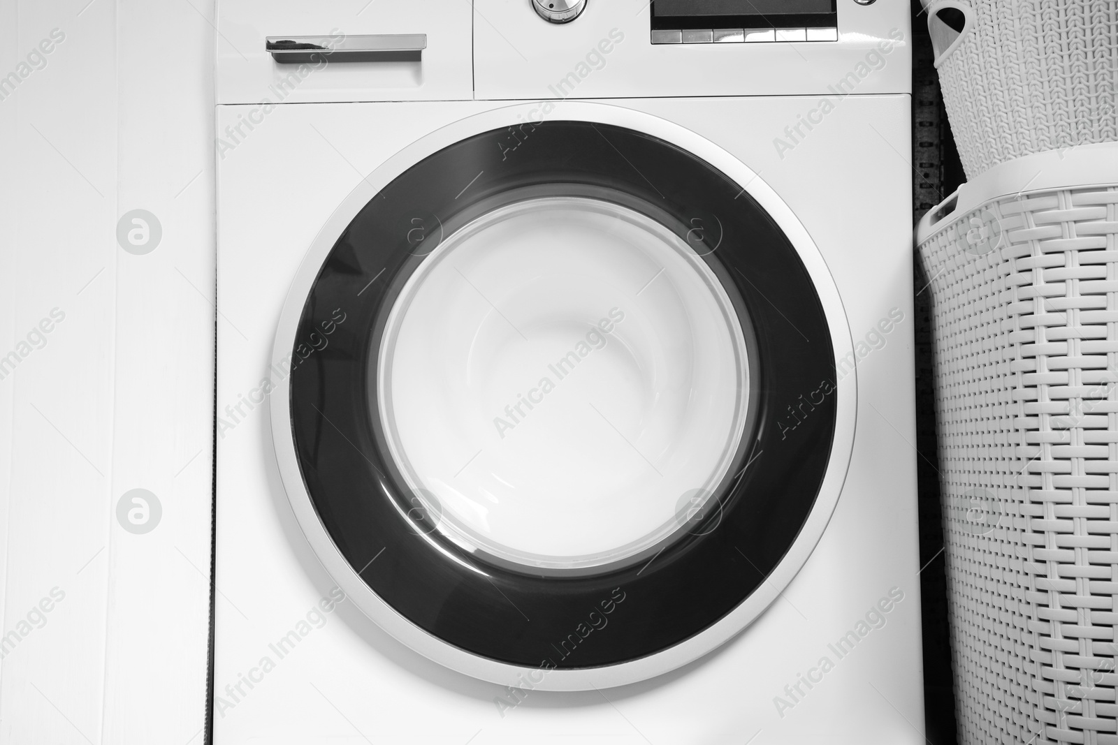 Photo of Washing machine with suds in bathroom, closeup