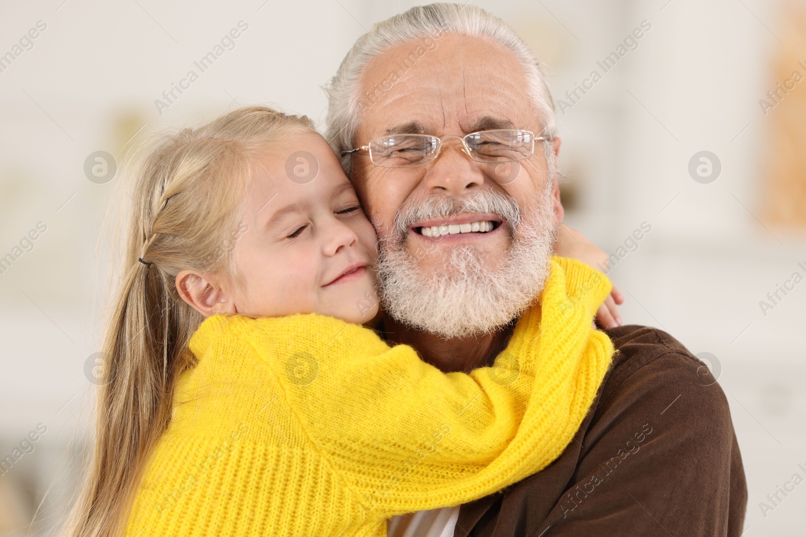 Photo of Grandpa and his granddaughter spending time together at home