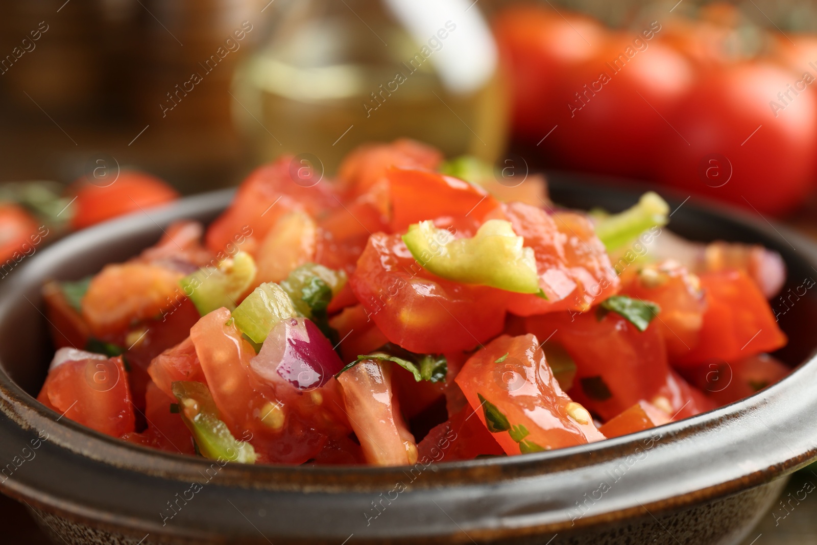 Photo of Delicious spicy salsa with herbs in bowl, closeup