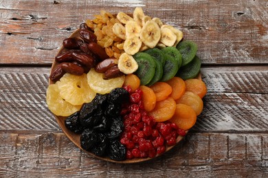 Photo of Different dried fruits on wooden table, top view