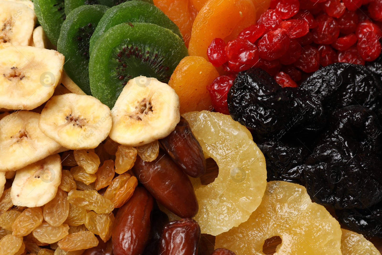 Photo of Mix of different dried fruits as background, closeup