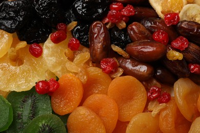 Photo of Mix of different dried fruits as background, closeup