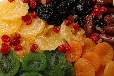 Photo of Mix of different dried fruits as background, closeup