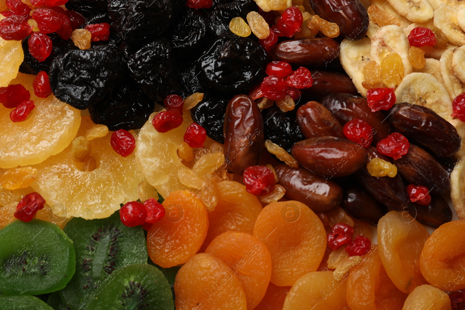 Photo of Mix of different dried fruits as background, closeup