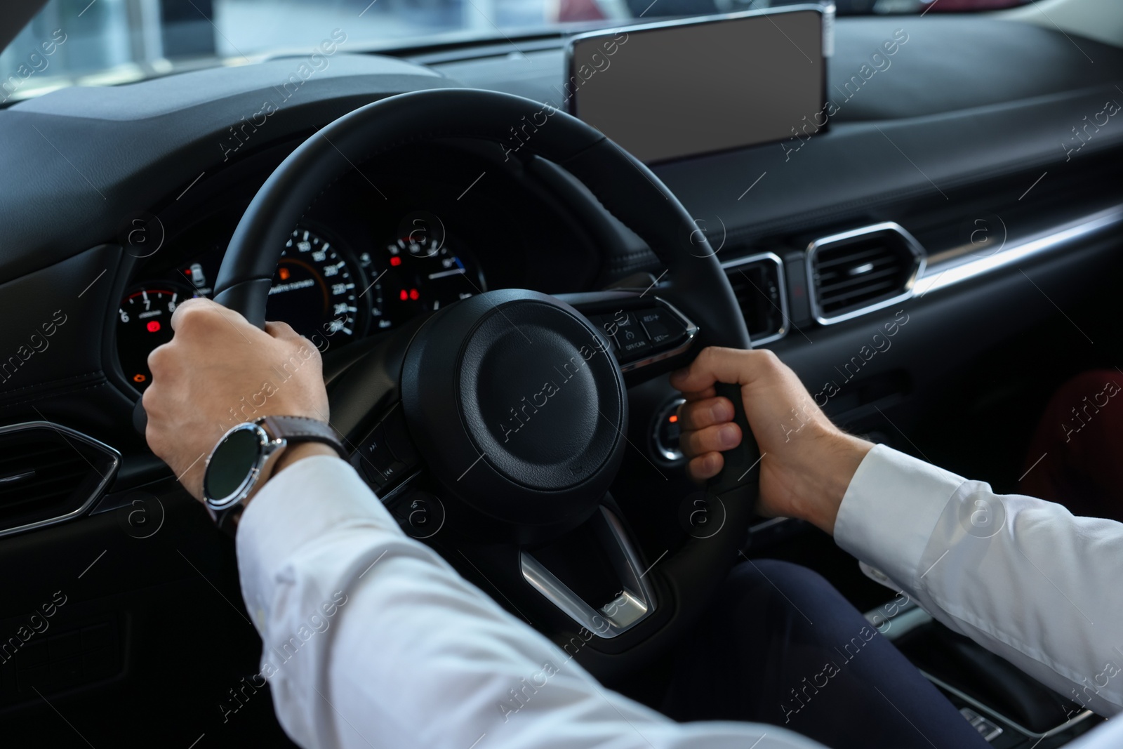 Photo of Man inside new car in salon, closeup