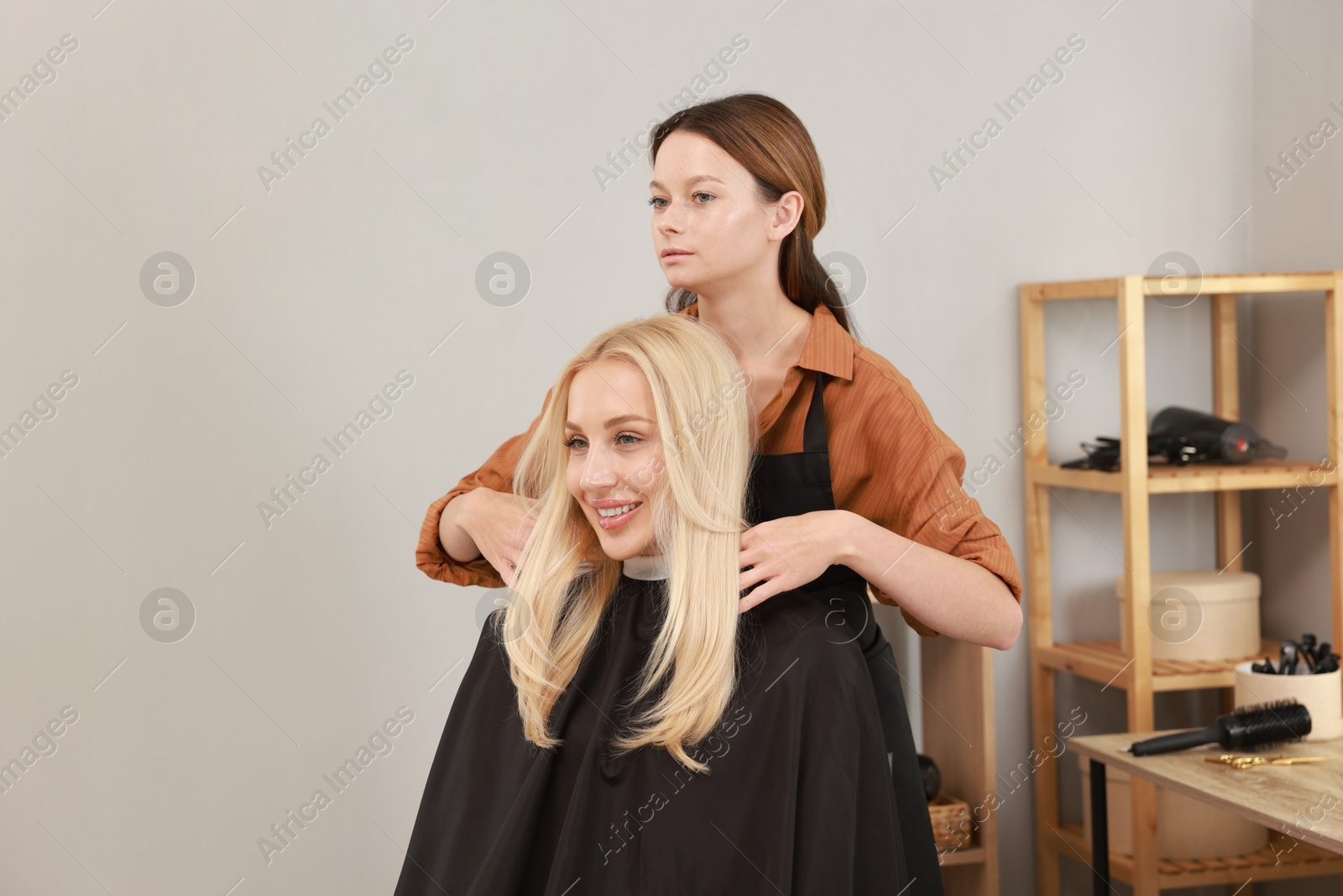 Photo of Hair cutting. Professional hairdresser working with client in salon