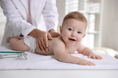 Photo of Pediatrician with little child in clinic, closeup. Checking baby's health