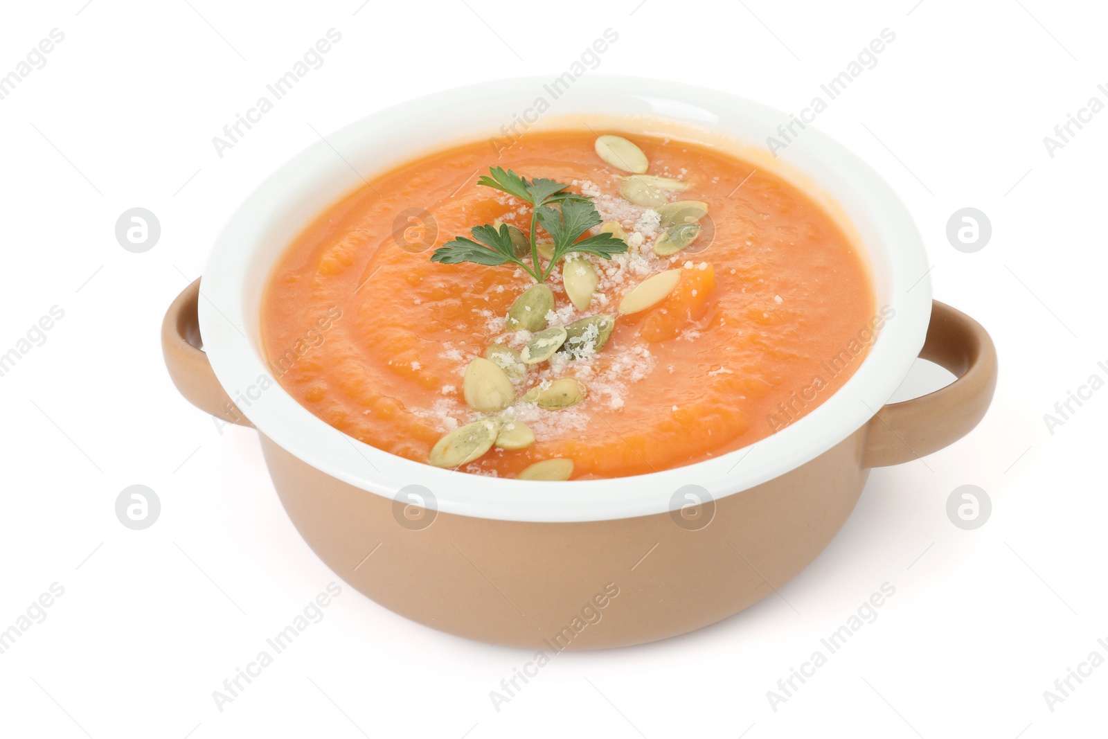 Photo of Delicious sweet potato soup with pumpkin seeds and parsley in bowl isolated on white