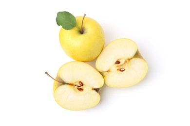 Photo of Whole and cut ripe yellow apples isolated on white, top view