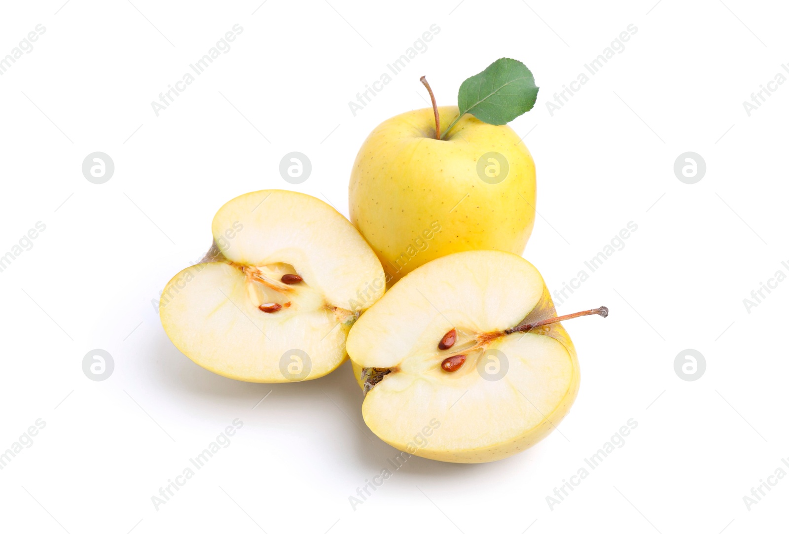 Photo of Whole and cut ripe yellow apples isolated on white