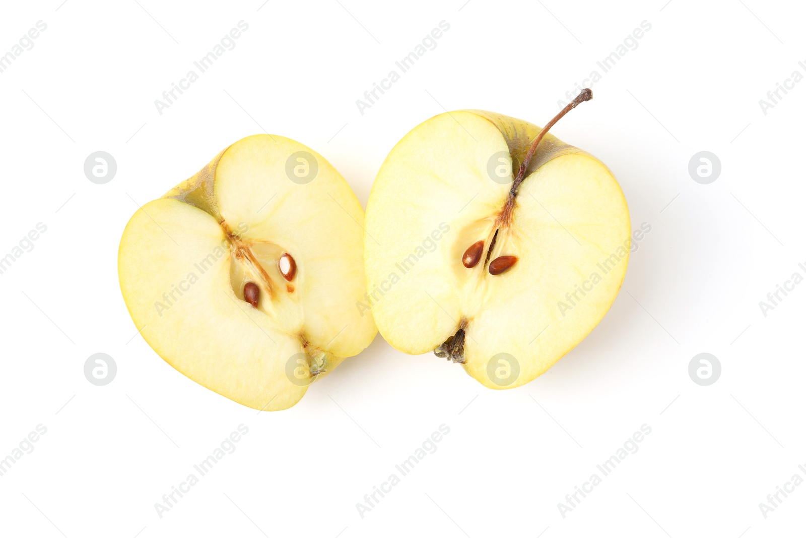 Photo of Halves of ripe yellow apple isolated on white, top view