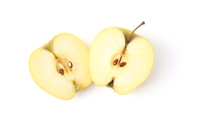 Halves of ripe yellow apple isolated on white, top view