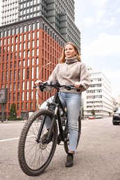 Photo of Beautiful woman with bicycle outdoors, low angle view. Healthy lifestyle