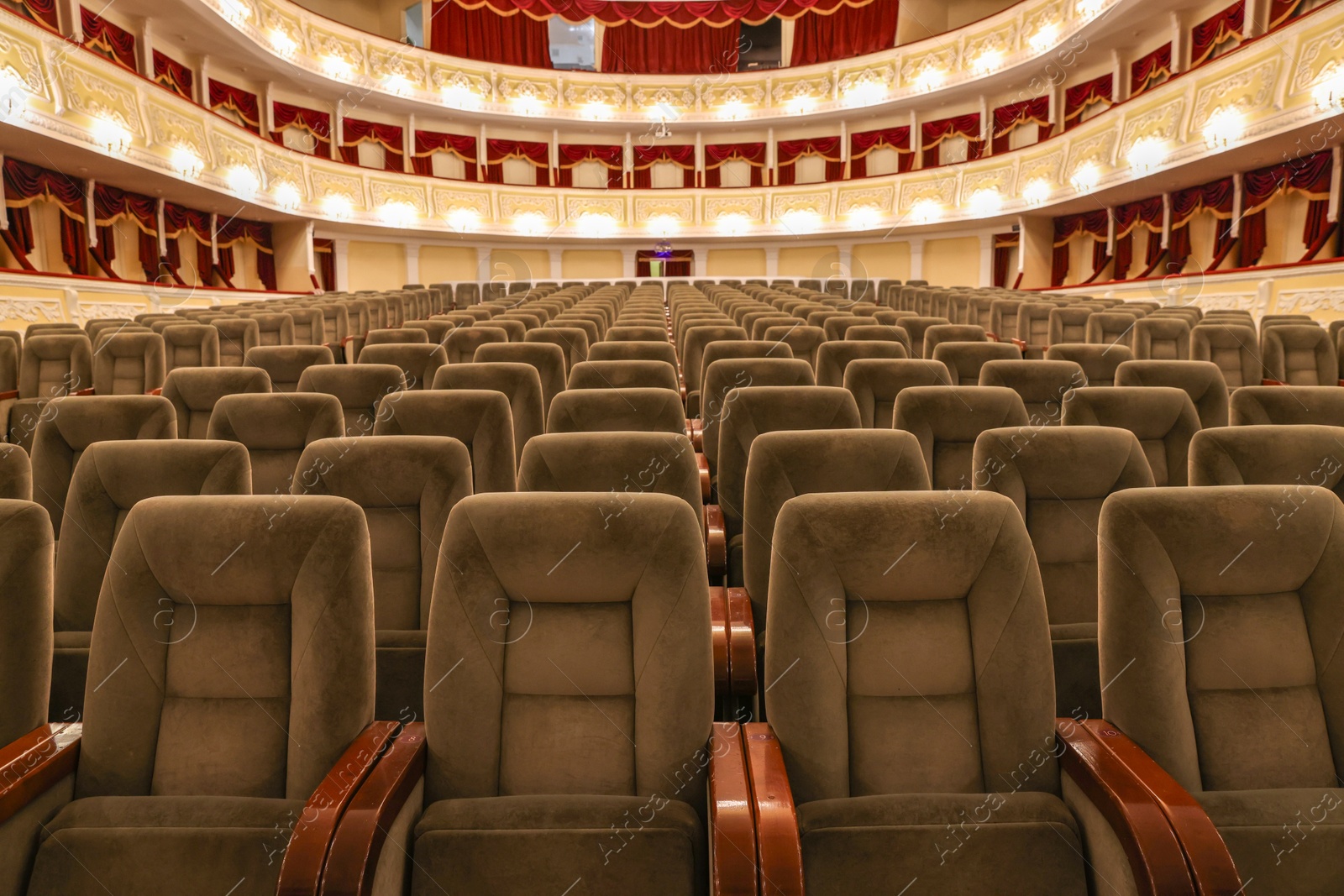 Photo of Rows of gray comfortable seats in theatre